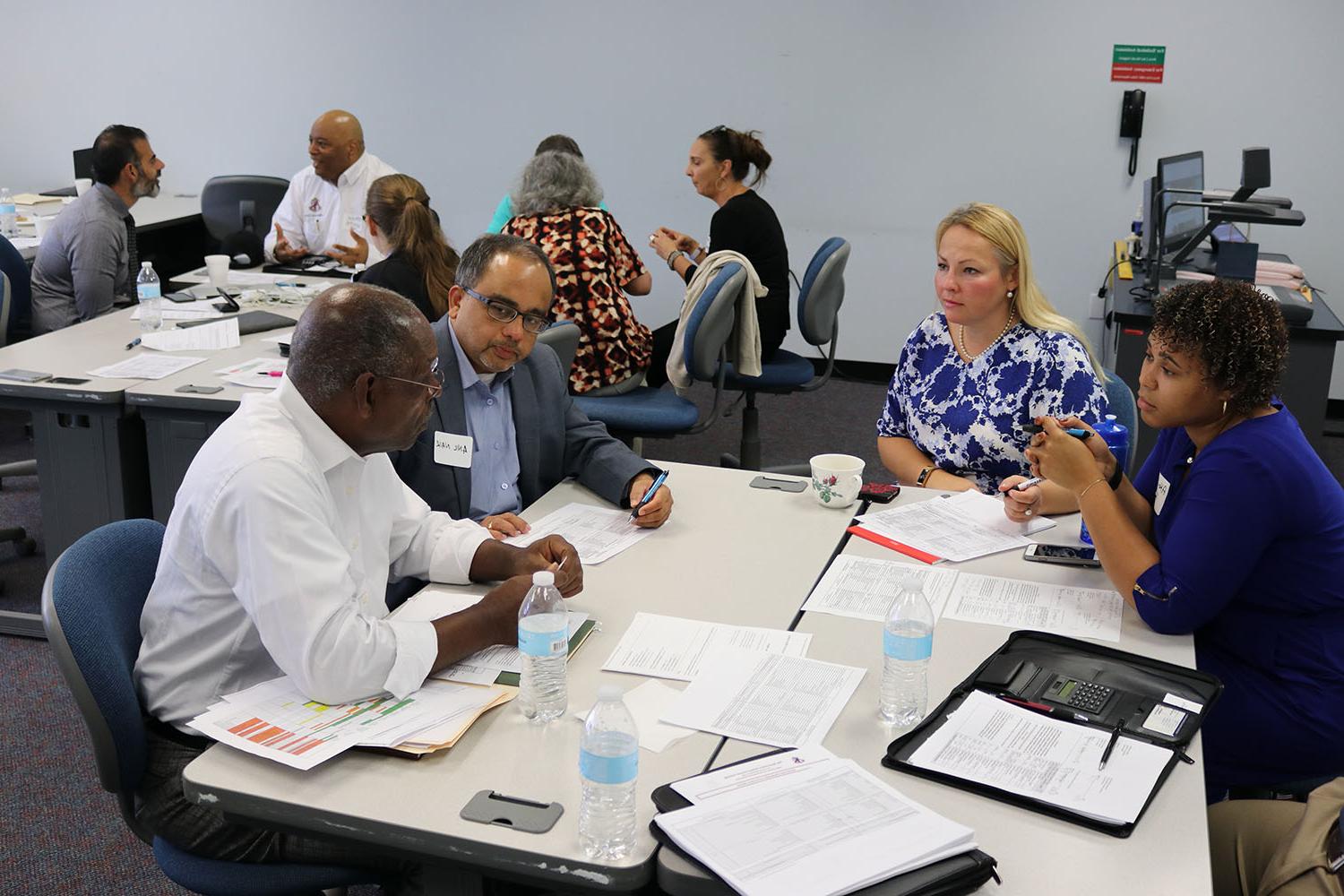 ODU Peninsula Higher Education Center faculty meet at table.