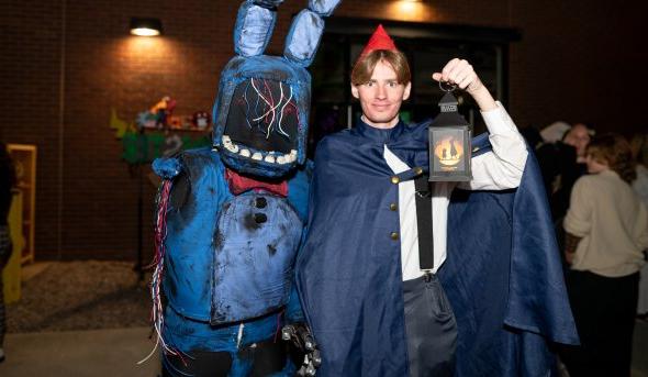 Two people in halloween costumes.