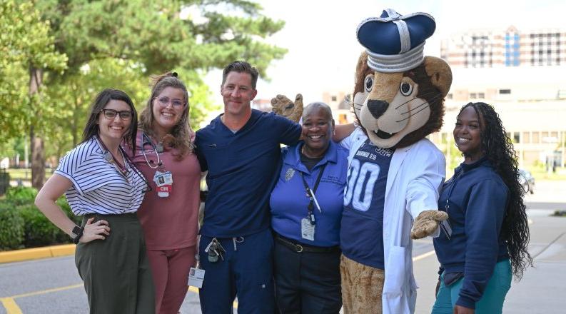 A group of people pose for a photo with Old Dominion University's mascot.