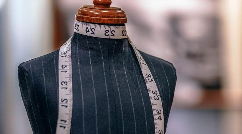 Fashion mannequin with measuring tape around neck 