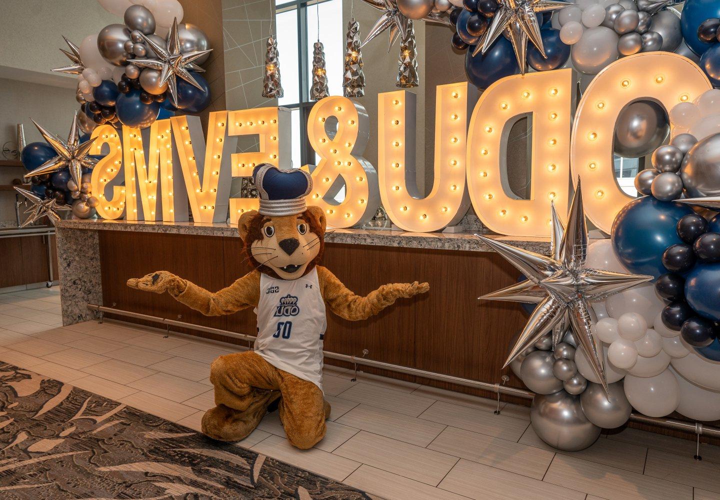 ODU's mascot poses in front of an ODU/EVMS sign. 