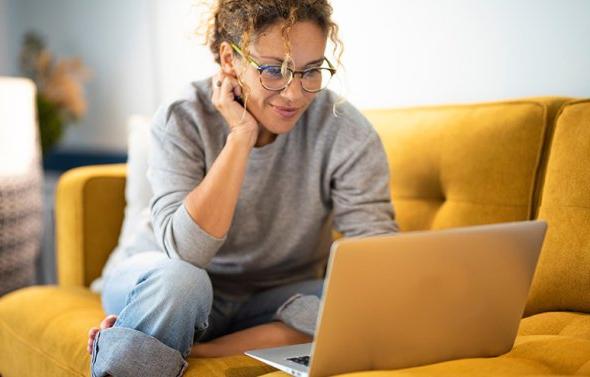 Woman at laptop couch