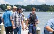 Two men walk on a dock