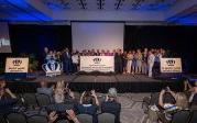 A group of people stand on a stage.