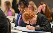 Two students sitting at a table.