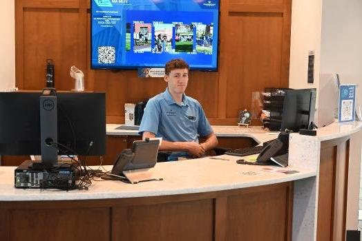 student at front desk